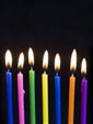 Семь ярких свечей на черном фоне и пожелание ярких дней в следующем году жизни...