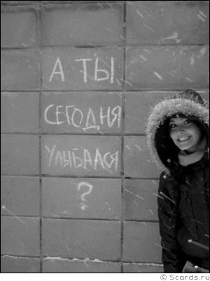 Улыбающаяся девушка стоит около надписи: А ты сегодня улыбался?